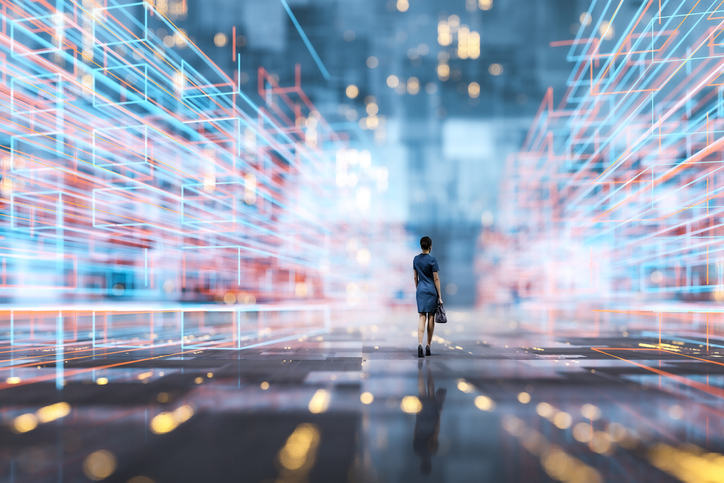 A person walks through a futuristic multicolored illuminated framework.