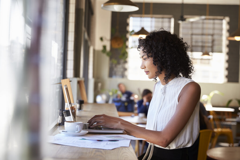 A professional woman gazes at a computer.