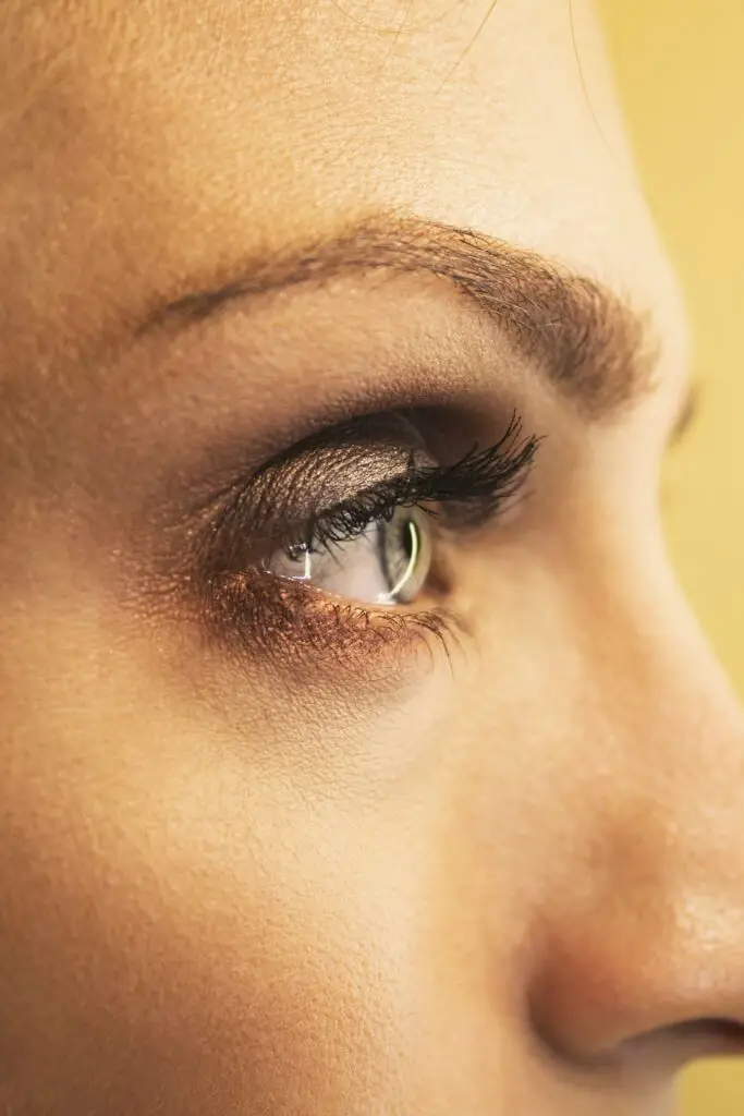 A closeup photo of a woman's hazel eye.