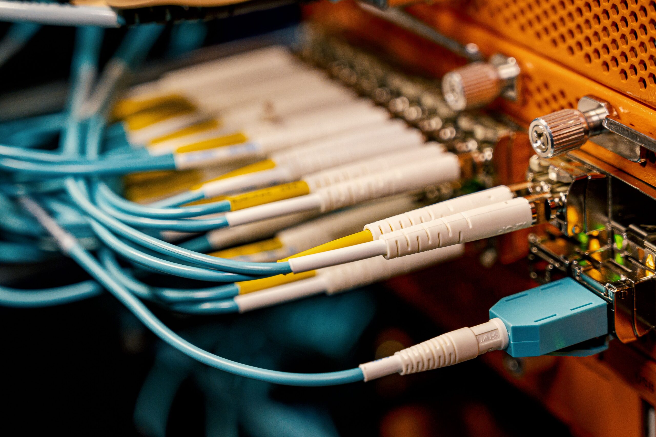 An electronic panel filled with neat rows of cables plugged into it.